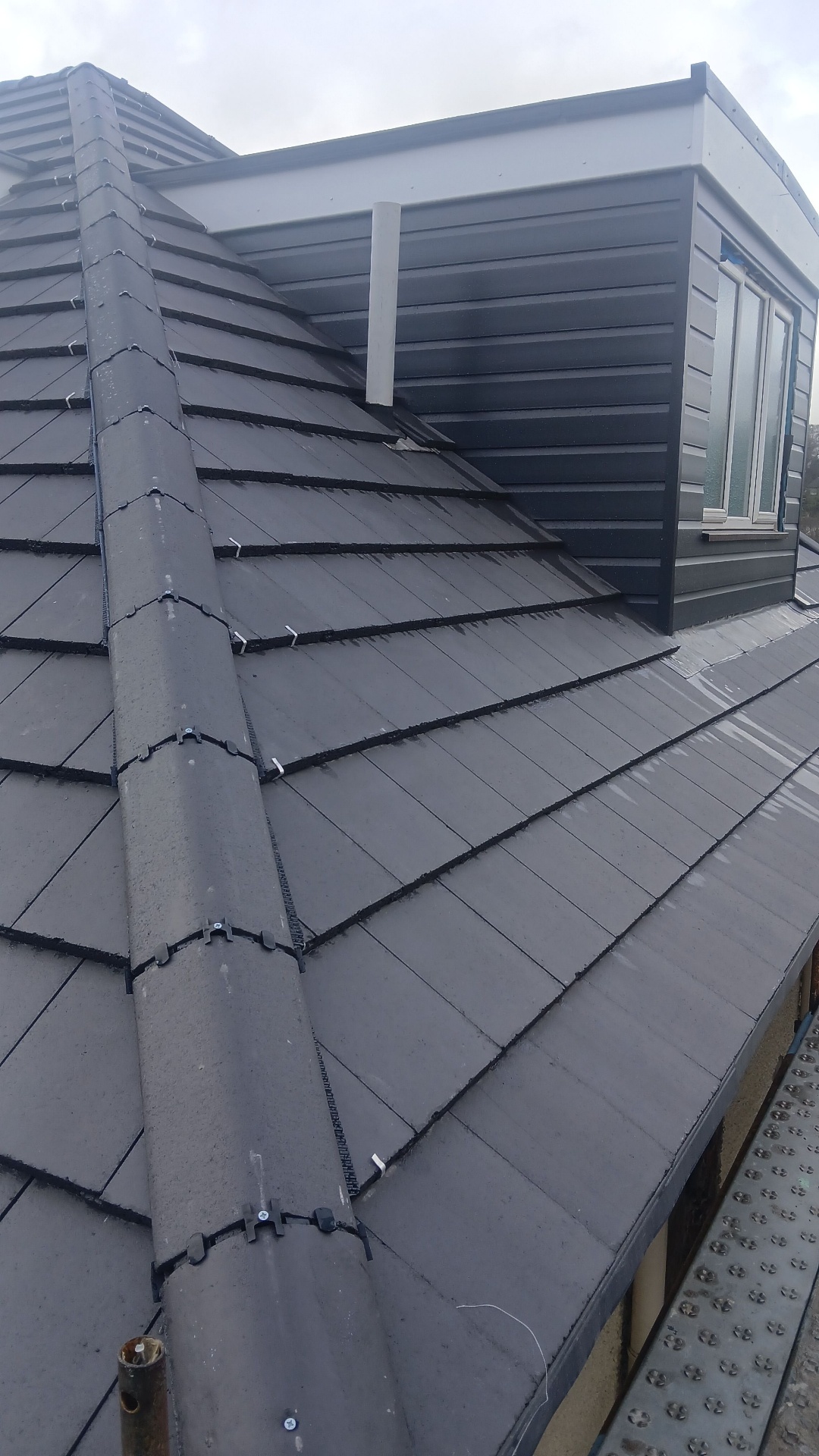Slate roof with dormer and dry-fix ridge system