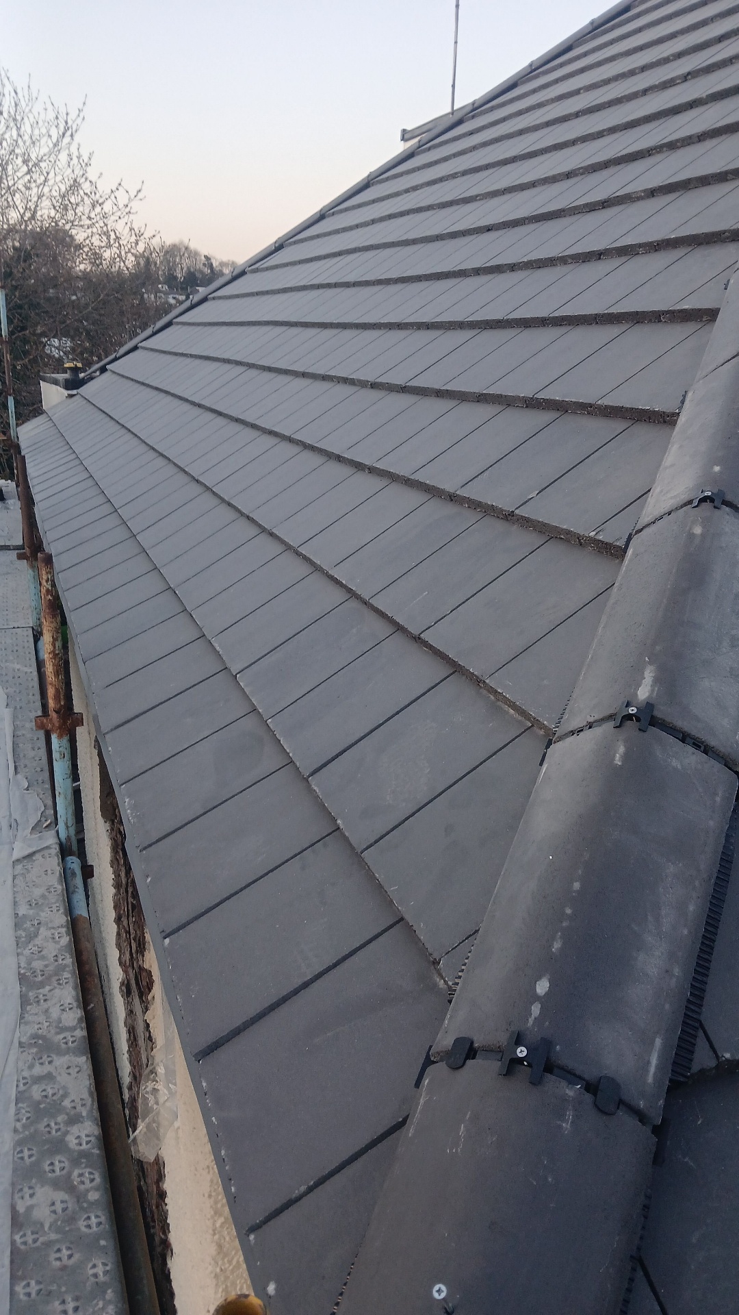 Freshly laid natural slate roof with lead ridge detail in Scotland