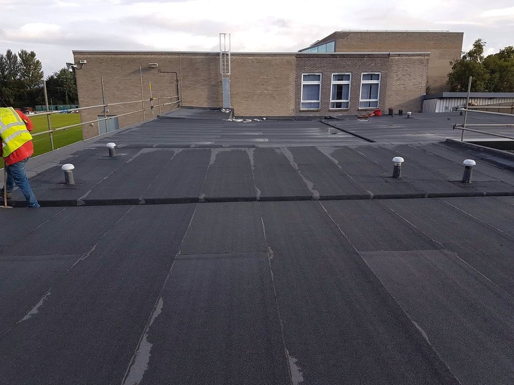 Large commercial torch-on felt flat roof installed by J Hope Roofing